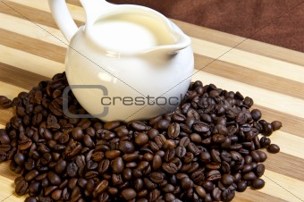 Jug of milk and coffee beans