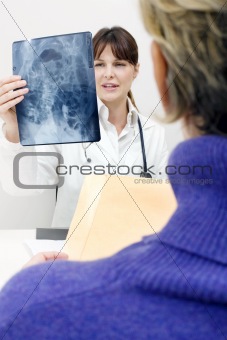 patient and female doctor examining an X-ray