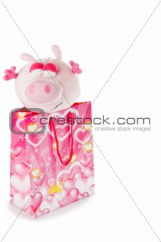 Toy piglet as christmas gift isolated on white