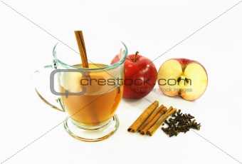 Hot apple cider in glass over white. 