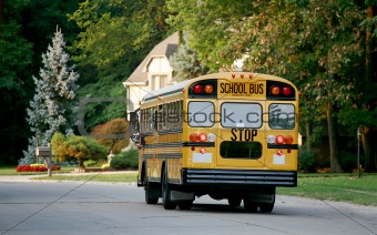 School Bus Driving Down Road