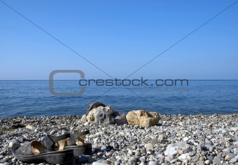 sea, sky, rocks and sandals