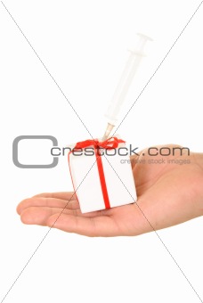 Syringe in gift on palm