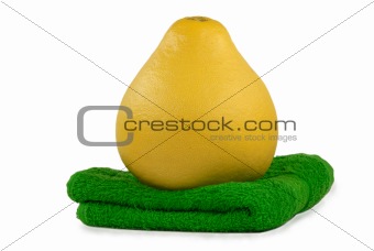 Fruit pomelo lies on green towel