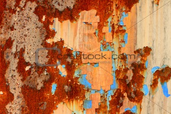 A rotted metal panel covered in rust 
