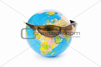 Globe with sunglasses isolated on the white