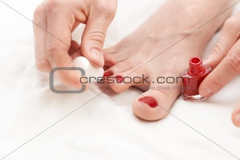 Woman makes pedicure by herself