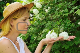 Young woman gardening - taking care of snowball