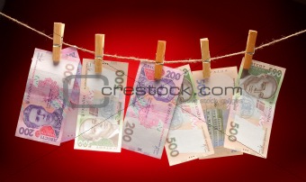 Ukrainian grivna notes Hanging on Rope with Clothespins