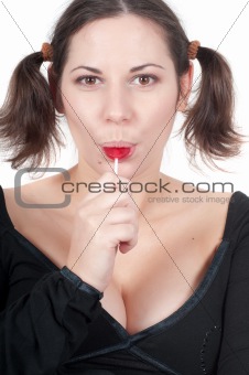Portrait of pretty woman in black eating candy