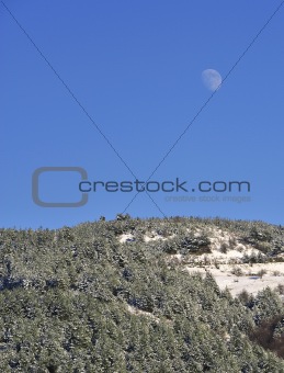 Moon over mountain in winter