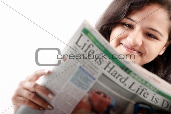 Smelling Indian teen reading newspaper