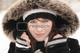 Young beautiful smiling woman in a striped hat
