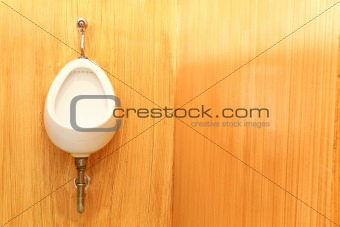 White urinal on the brown   wood textures background 
