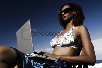 young mixed woman working on laptop