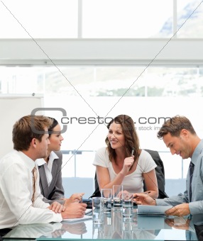 Glad businesswoman talking to her team