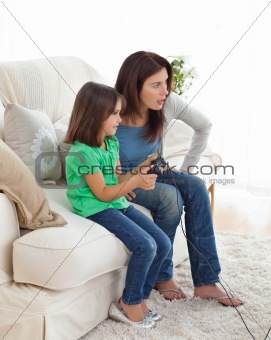 Concentrated mom and daughter playing video games
