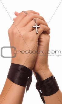 Woman is praying holding the cross