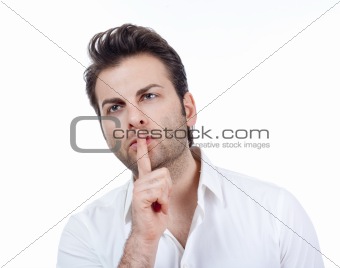 man in white shirt doing a silence gesture with forefinger - isolated on white