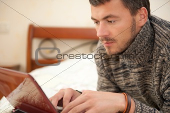 young man with laptop computer at home