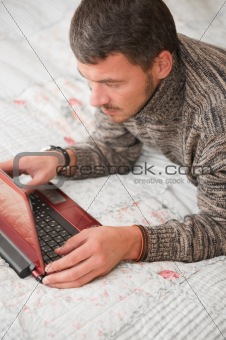 young man with laptop computer at home