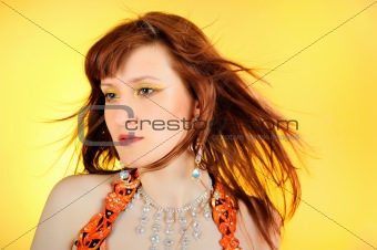 Beautiful mystic woman with golden make-up . yellow background