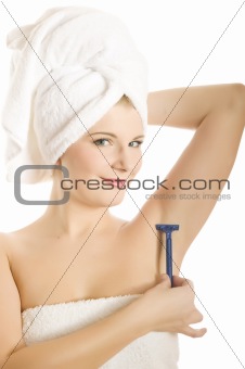 pretty woman shaving with razor