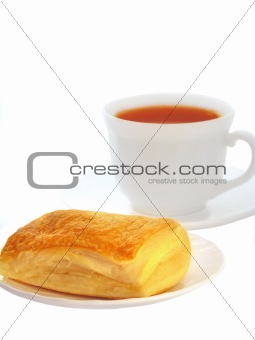 Appetizing puff with tea isolated on a white background 
