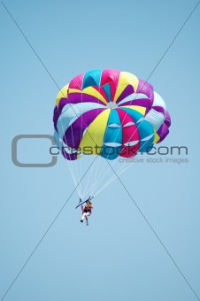 Multi coloured parachute over the blue sky