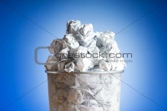 Garbage bin with paper waste isolated on white 