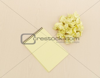 Notebook and crumpled paper