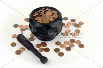 Grinding for Pennies - Wood mortar and pestle containing pennies bills on a white background.