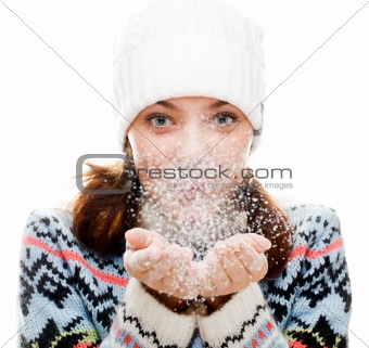Beautiful woman blowing snow 