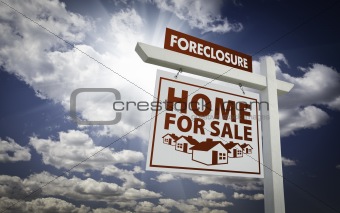 White Foreclosure Home For Sale Real Estate Sign Over Beautiful Clouds and Blue Sky.