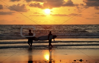 Surfers on sunset