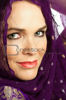 Closeup portrait of a beautiful Indian woman wearing a head scar