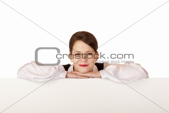 Young happy woman leans on blank billboard