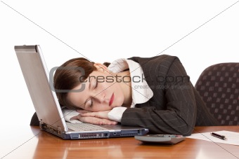 Tired overworked business woman sleeps in office on laptop