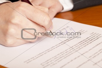 Close-up macro of signing a contract