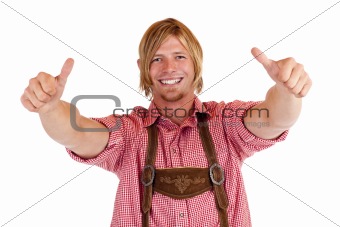 Bavarian man with oktoberfest leather trousers (Lederhose) shows both thumbs up