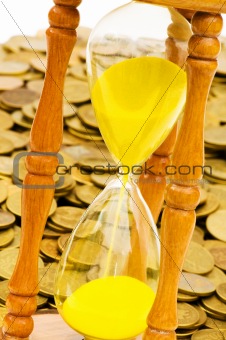 Time is money concept - hourglass and coins