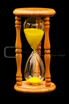 Wooden hourglass isolated on the balck background