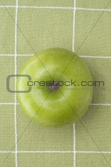 Fresh Green Apple on a Green Background