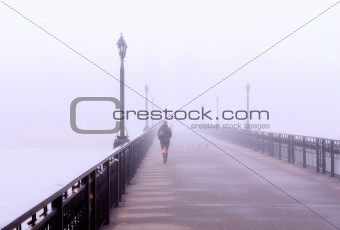 A lonely lady crossing a bridge
