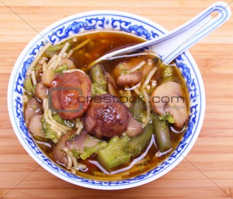 Vegetarian chinese soup with noodles and mushrooms 