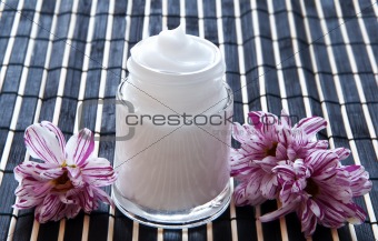 Cream and flower on a bamboo