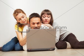 Happy friends with laptop computer