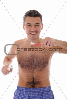 Middle aged man brushing his teeth in the morning. isolated