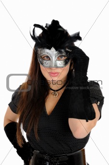 Beautiful brunette woman in black dress in party carnival mask .