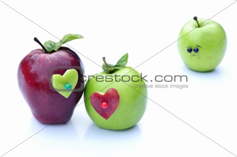 A couple of apples lovers embrace in front of lonely apple
